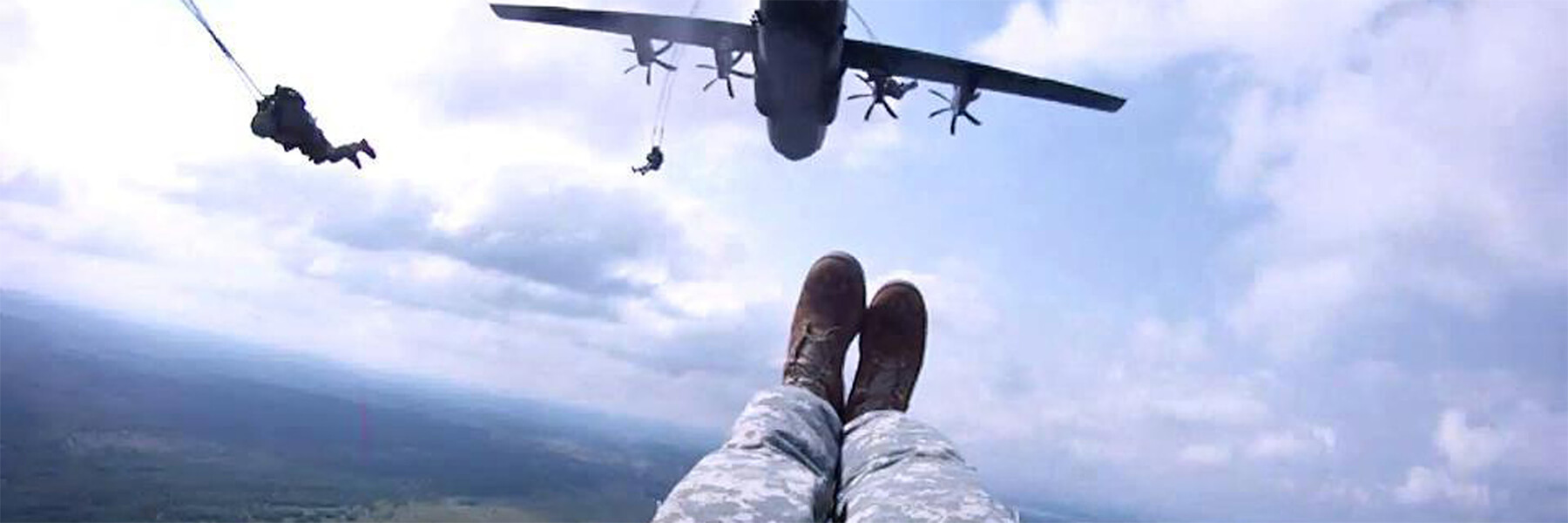 Army soldiers Parachuting out of a plane