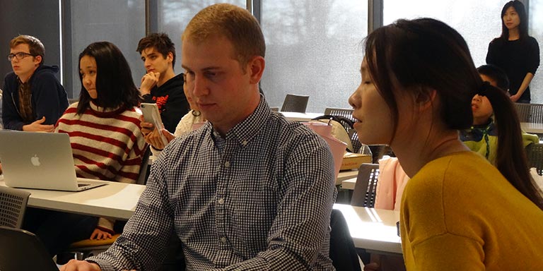 Two students looking at a laptop
